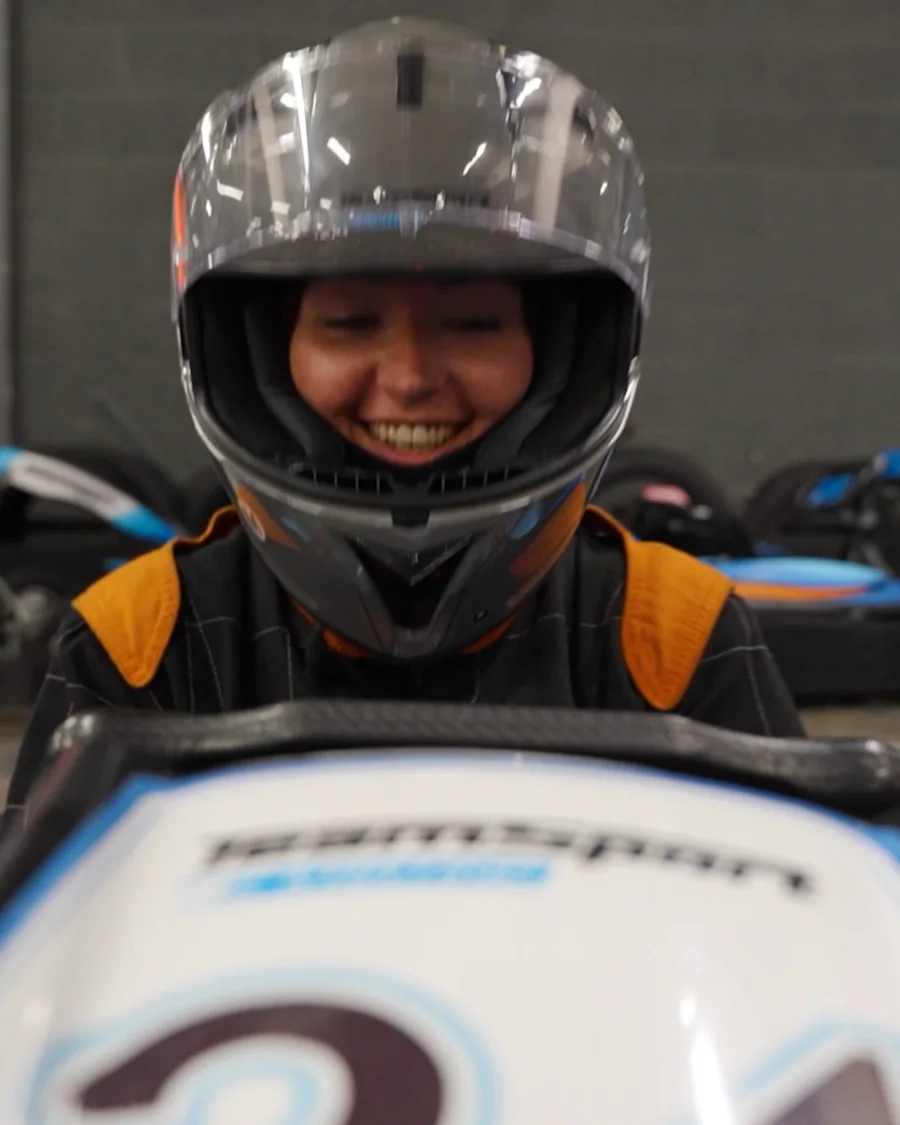 A colleague grinning in a helmet at the Leadly karting day