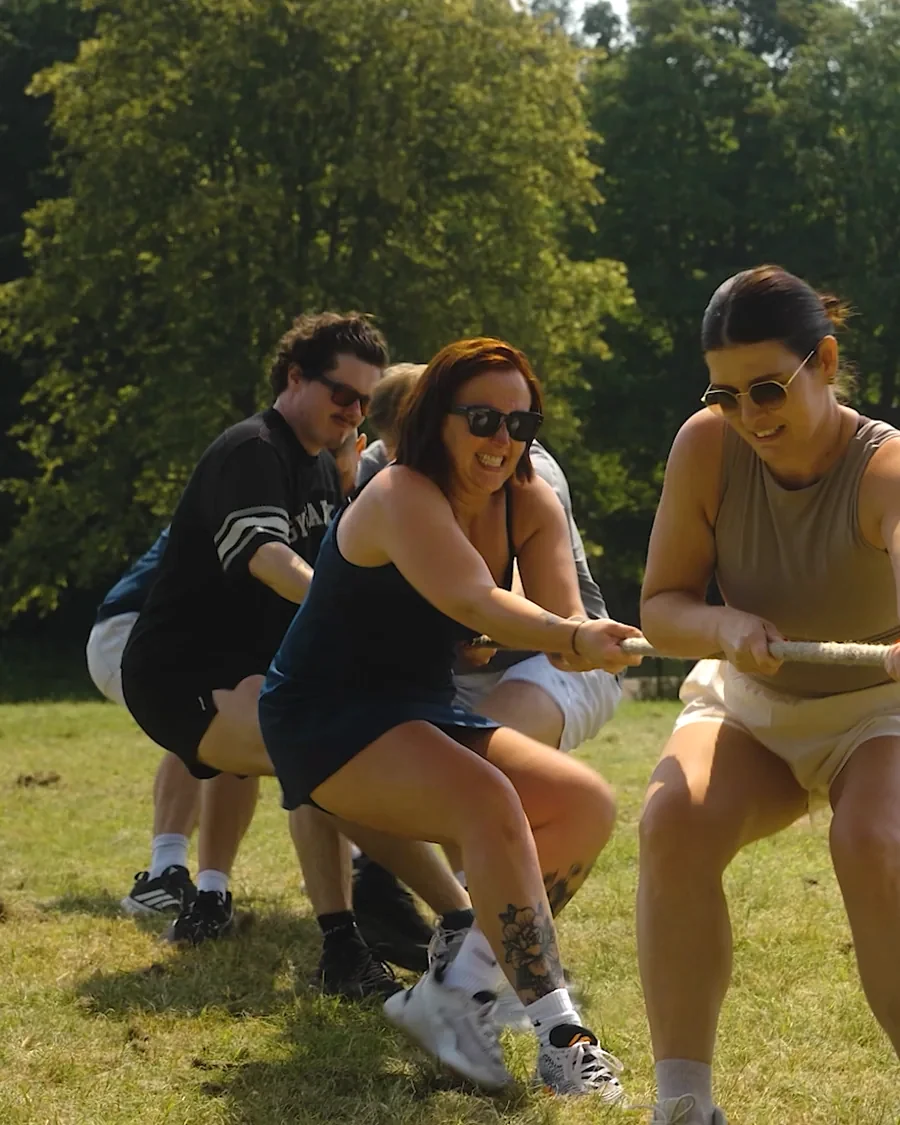 Colleagues pulling together in a tug of war on a Good Vibes Day