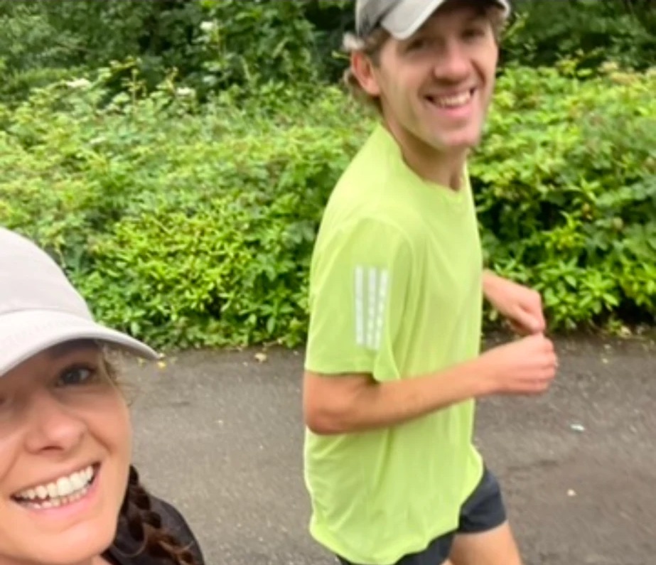 Two colleagues smiling on a run together