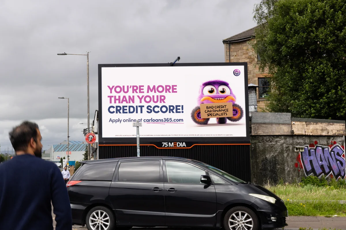 A carloans365 digital billboard in Glasgow reading “You’re more than your credit score”